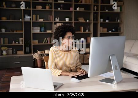 Concentrated young african american businesswoman working on computer. Stock Photo