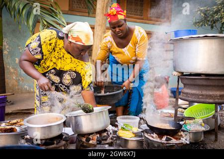 African woman cooking traditional food at street Stock Photo