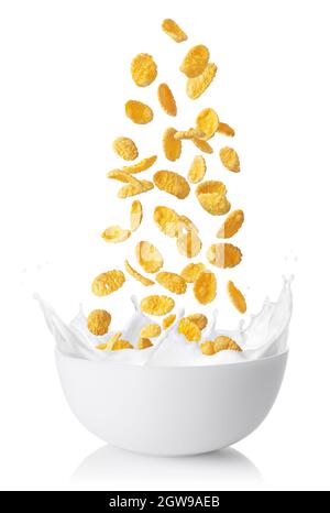 cornflakes falling into bowl with milk splashes isolated on white Stock Photo