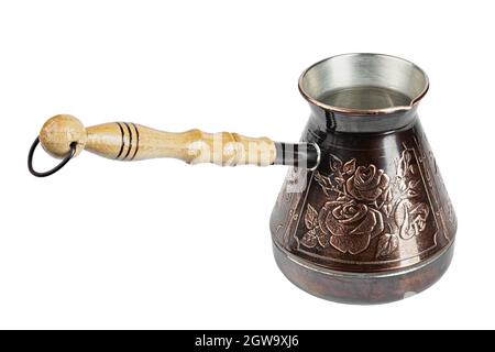 Turkish coffee pot. Ibrik - small copper coffee pot isolated on white background. File contains clipping path. Stock Photo