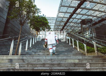 spaceman in a futuristic station. Man with space suit walking in an urban area Stock Photo