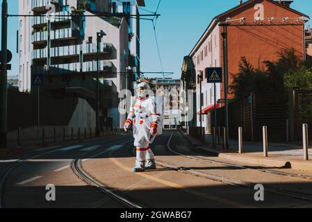 spaceman in a futuristic station. Man with space suit walking in an urban area Stock Photo