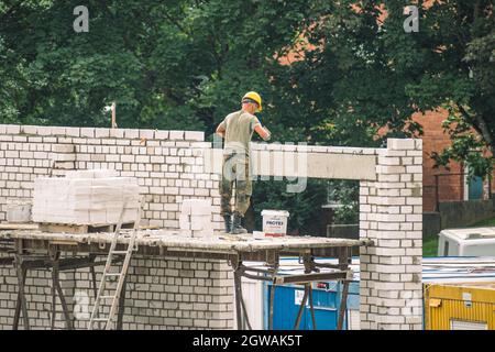 New buildings or houses under construction with workers with helmet at work Stock Photo