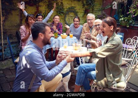 big surprise for young adult beautiful caucasian female as well as for people around by the beardy guy who just propose her to marry him Stock Photo