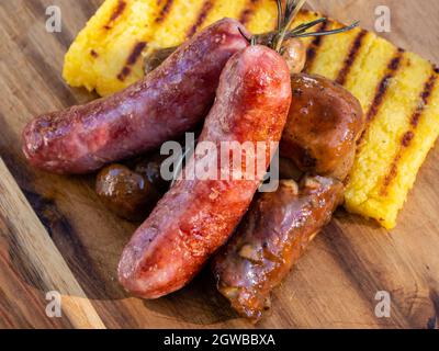 Salsiccia Italian Sausage with Sauteed Funghi Porcini or Cep Mushrooms and Grilled Polenta Close Up Detail Stock Photo