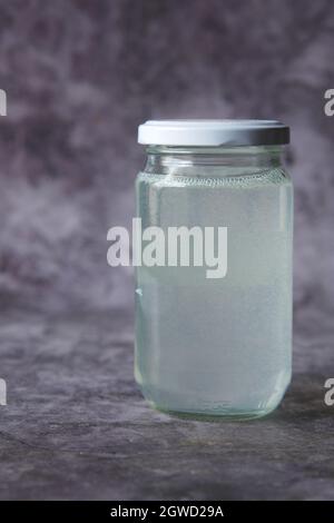 coconut oil in a glass jar on black background  Stock Photo