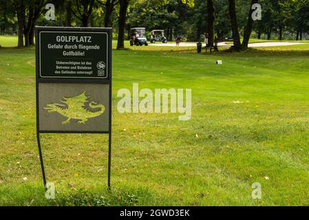 Beware of golf balls: warning sign at the colf course of the dragon-town Furth im Wald. Stock Photo