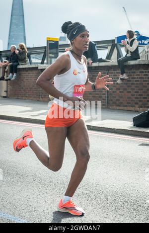 London, UK. 3rd Oct, 2021. (Eventual elite women's race 2nd place) Degitu AZIMERAW (ETH) passes mile 24 at Blackfriars in the London Marathon, the first time it has been held since April 2019 due to the Covid-19 pandemic. Over 36,000 elite athletes, club runners and fun runners are taking part in the mass event, with another 40,000 people taking part virtually. Credit: Stephen Chung/Alamy Live News Stock Photo