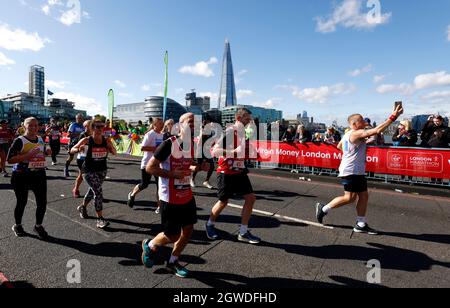 Runners cross over Tower Bridge during the Virgin Money London Marathon. Picture date: Sunday October 3, 2021. Stock Photo