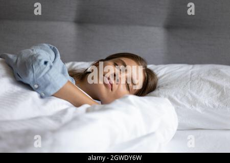 Calm Pretty Woman Sleeping Peacefully on White Sheets in Bed Stock