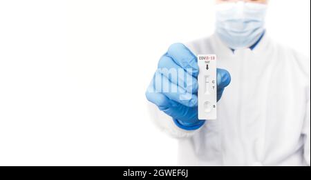 The doctor showing Covid-19 negative test result of the antigen rapid test kit on white background,copy space,Coronavirus infectious protect concept. Stock Photo