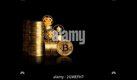 Gold Bitcoin and other coin on the gold coins stack of crypto currency with a black background,virtual digital money concept Stock Photo