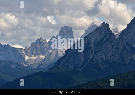 The Dolomite group of Cristallo partially covered by the Daumkofel peak and the last slopes of Monte delle Rondini Stock Photo