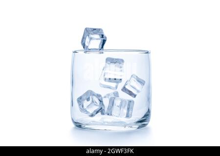 drop ice cubes in to empty Rock glass or Old Fashioned glass isolated on white background, glassware concept Stock Photo