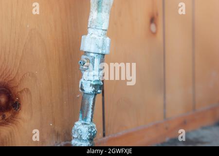 Old leaking pipe with broken isolation valve screw, compression tap fitting, showing water and limescale damage Stock Photo