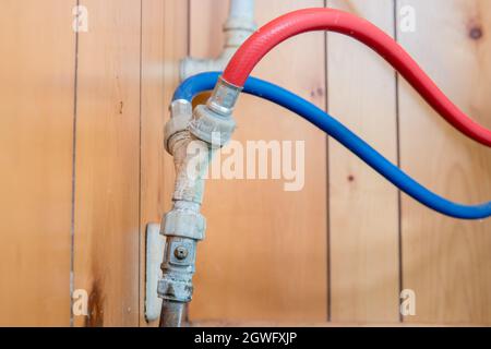 Original dual hot and cold fill pipe with y piece connector, broken compression valve, in old house Stock Photo