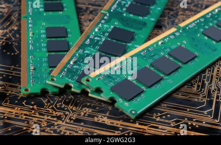 computer memory modules on background of black printed circuit board with golden wires Stock Photo