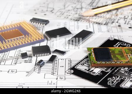 Electronic board, pen, processor and radio components on background of  schematic circuit diagram and a photomask for manufacture of printed circuit b Stock Photo