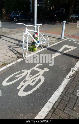 A cycle ghost bike (also referred to as ghostcycle or WhiteCycle) bicycle roadside memorial, where a cyclist was killed in Richmond, London UK. (127) Stock Photo