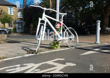 A cycle ghost bike (also referred to as ghostcycle or WhiteCycle) bicycle roadside memorial, where a cyclist was killed in Richmond, London UK. (127) Stock Photo