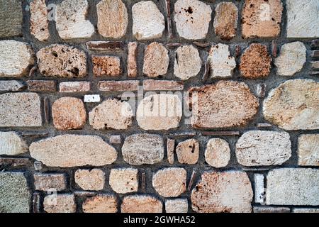 stone texture, stone wall background. an old shabby wall made of stone textured blocks. Stock Photo