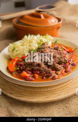 A stew made from slow cooked ox cheeks with vegetables, kidney beans and home grown chillies. England UK GB