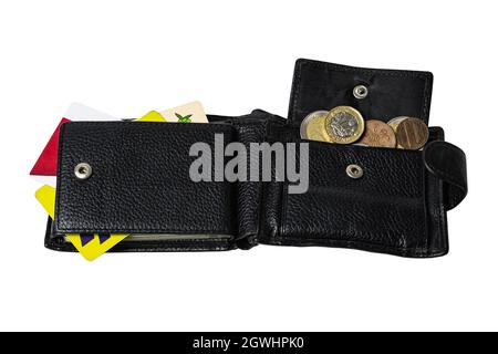 men's wallet in black color lies on a flat surface on a white background you can see different coins Stock Photo