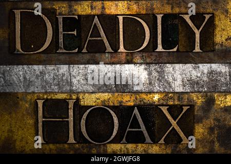 Deadly Hoax text on textured grunge copper and vintage gold background Stock Photo