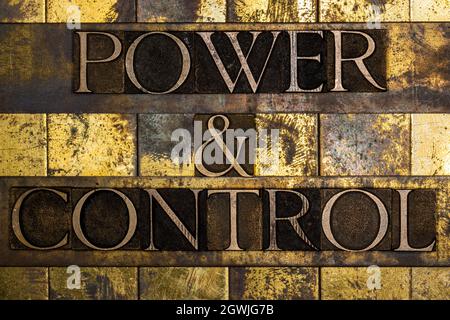 Power and Control text on textured grunge copper and vintage gold background Stock Photo