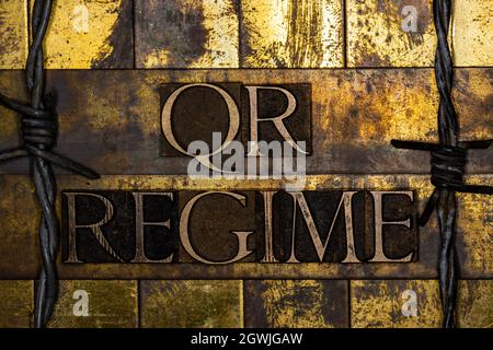 QR Regime text on textured grunge copper and vintage gold background Stock Photo