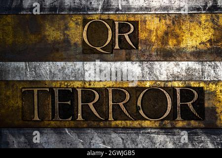 QR Terror text on textured grunge copper and vintage gold background Stock Photo