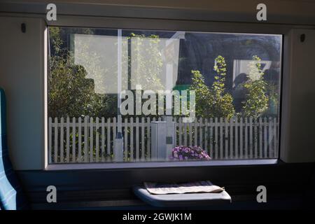 View of a station through a window of a train in the uk. Stock Photo
