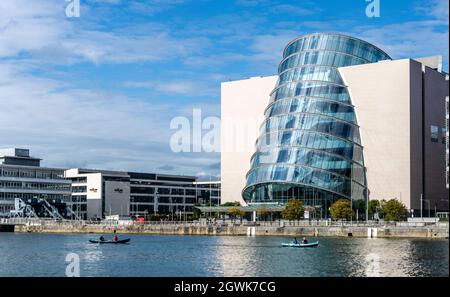 Rowers from St Patricks Rowing Club in Ringsend, Dublin, Ireland, passing the Convention Centre as they make their down the River Liffey. Stock Photo