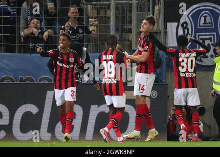 03 October 2021, North Rhine-Westphalia, Bielefeld: Football: Bundesliga, Arminia Bielefeld - Bayer Leverkusen, Matchday 7 at the SchücoArena. Leverkusen's goal scorer Patrik Schick (2nd from right) celebrates his goal to make it 0:2 with Amine Adli (l-r), Moussa Diaby and Adrian Stanilewicz. Photo: Friso Gentsch/dpa - IMPORTANT NOTE: In accordance with the regulations of the DFL Deutsche Fußball Liga and/or the DFB Deutscher Fußball-Bund, it is prohibited to use or have used photographs taken in the stadium and/or of the match in the form of sequence pictures and/or video-like photo series. Stock Photo