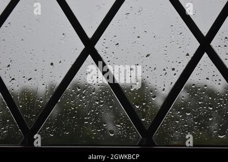 Drops of rain on a window with triangular-shaped leading. Stock Photo