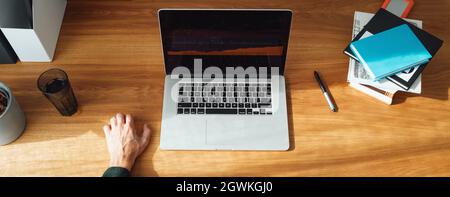 Top view of  businessman trader investing in online world stock exchange. Male working with stock market and analysing securities trend. Wide image Stock Photo