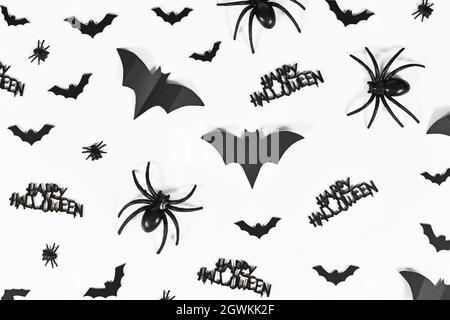 Black Halloween bats, spiders, flies and Happy Halloween text on white background Stock Photo