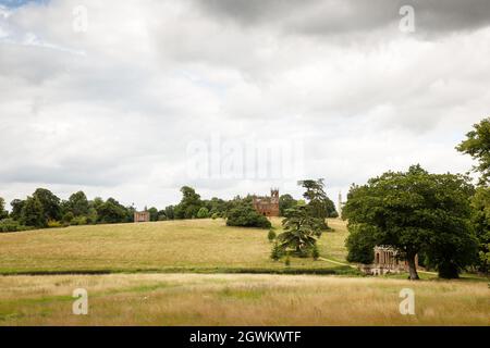 landscape image of stowe gardens with the Palladian Bridge, The Gothic Temple, Cobham Monument  and the The Queen's Temple in the background Stock Photo