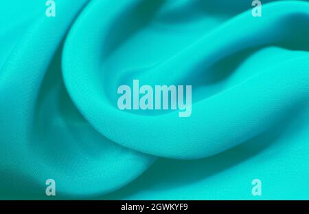 A piece of turquoise,aquamarine, blue. cloth. Fabric texture for background and design works of art, beautiful wrinkled pattern of silk or linen. A cr Stock Photo