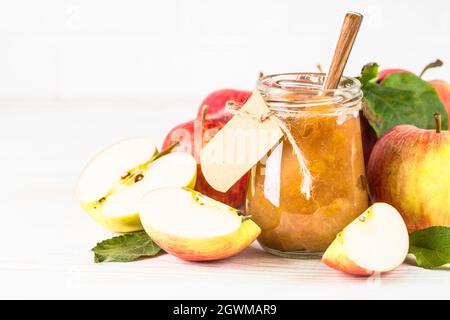 Apple jam with fresh apples on white background. Stock Photo