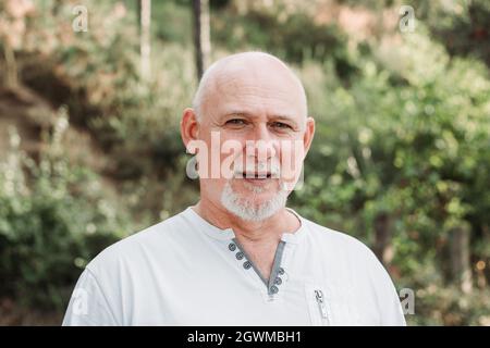 Handsome bald middle-aged man. Portrait in nature Stock Photo
