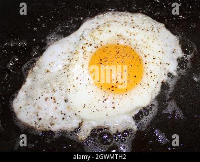 Sunny side up egg with pepper. Stock Photo
