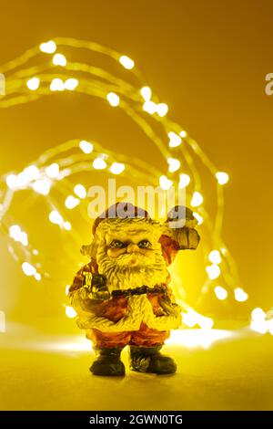 Santa Claus figure with lantern and toys with lights in background and copy space Stock Photo