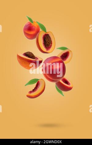 Flying fresh ripe nectarines - peaches with green leaves levitating  against yellow background. Creative minimal concept of food levitation. Stock Photo