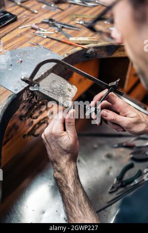 Stock Photo Of Concentrated Man Working With Tools In Artisan Workshop