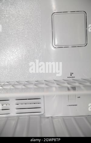 Empty shelves inside a clean, empty, white refridgerator Stock Photo