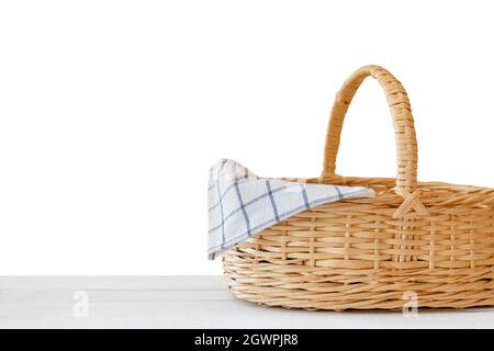 Isolated empty wicker basket on white wooden table. Template mock up for product display Stock Photo