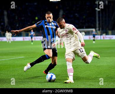 Bergamo, Italy. 3rd Oct, 2021. AC Milan's Ante Rebic (R) vies with Atalanta's Merit Demiral during a Serie A football match between Atalanta and AC Milan in Bergamo, Italy, Oct. 3, 2021. Credit: Str/Xinhua/Alamy Live News Stock Photo