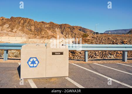 Trash and recycle beans on parking lot in public park. Mountains and blue sky background, copy space. Environment protection, pollution, recycling and Stock Photo