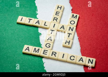 October - National Italian American Heritage Month, crossword against paper abstract in colors of national flag of Italy (green, white and red), remin Stock Photo